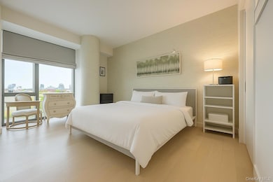 Bedroom with light wood-type flooring and a view of city