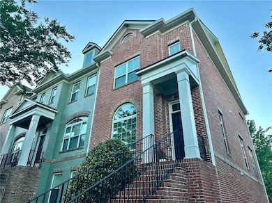 View of front and side facade featuring brick siding
