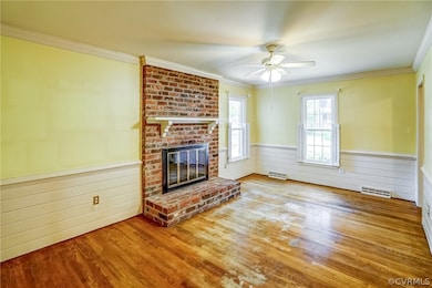 Unfurnished living room with ceiling fan, brick wa