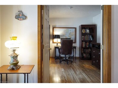The office has French doors, wood floor, and morni