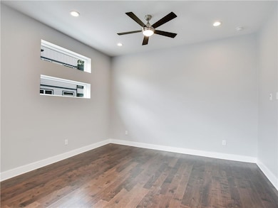 Unfurnished room featuring baseboards, recessed l
