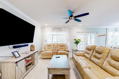 Living room featuring ornamental molding, french d