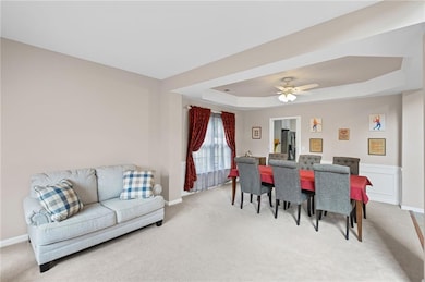 Formal dining room features trey ceiling and judge's paneling