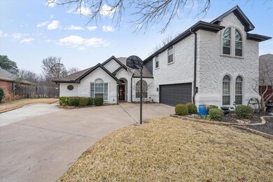 French provincial home with a garage and a front l