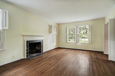 Living room with fireplace and courtyard views.