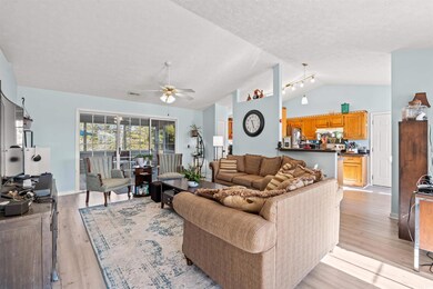 Living room featuring a textured ceiling, light ha