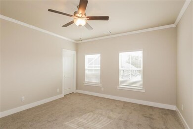 Empty room featuring crown molding, ceiling fan, l