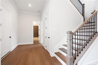 Entryway featuring crown molding and wood-type flo