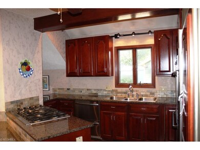 Updated kitchen with 5-burner cook top, cherry cabinets, & subzero fridge!