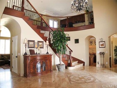 Formal Entry with Grand Curved Staircase up to the