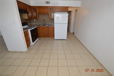 Kitchen with freestanding refrigerator, gas range
