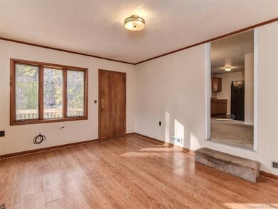 The den overlooks the back deck and through into the living area.  Gas Log Fireplace just to the left.