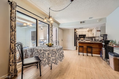 Dining room featuring light wood-style floors, a t