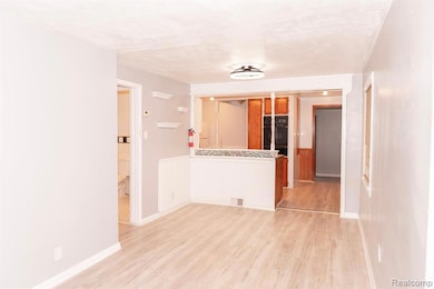 Empty room featuring light wood-style floors and wainscoting