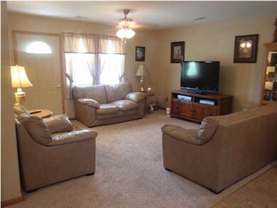 This welcoming living room has neutral decor and n