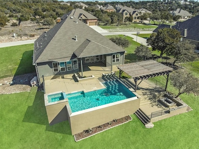 View of swimming pool featuring a patio area and a pool with connected hot tub