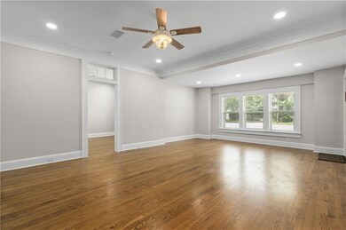 Empty room featuring ornamental molding, a ceiling fan, wood finished floors, recessed lighting, and baseboards