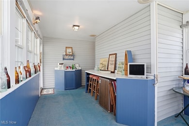 View of patio with a sunroom