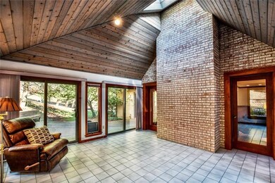Heated sunroom with vaulted ceilings, which leads 
