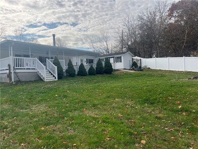 Back of property white vinyl privacy fence.