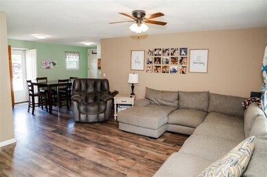 Living area featuring wood finished floors and ceiling fan