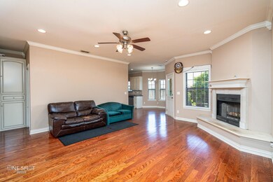 Living room featuring ceiling fan, hardwood / wood