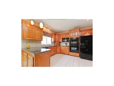 Kitchen with Granite, Stone Backsplash & double Ov