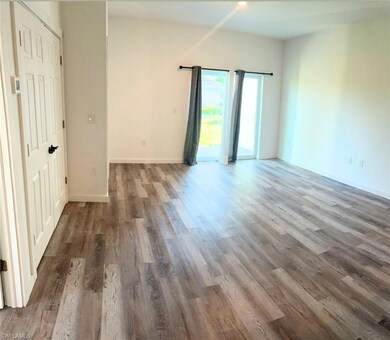 Empty room with wood finished floors and baseboards