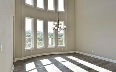Unfurnished dining area with dark wood-style floo