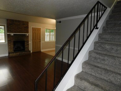 Stairs featuring a textured ceiling, baseboards, 