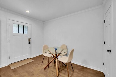 Dining room with ornamental molding, wood finishe