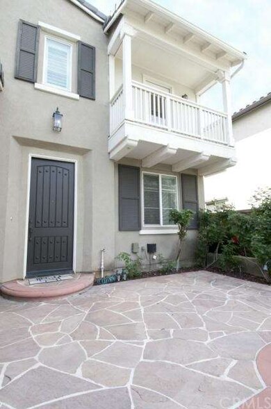 Another view of the front of the home with a balco