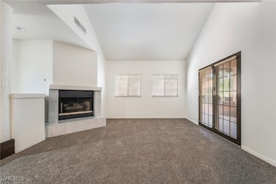 Unfurnished living room featuring lofted ceiling,