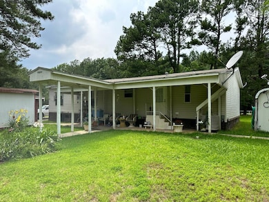 Rear view of house featuring a lawn