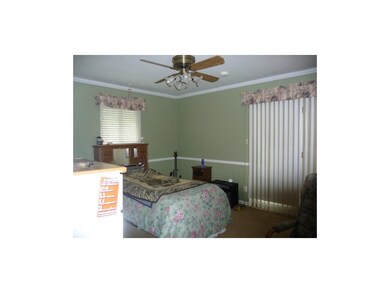 Master bedroom with venetian blinds covering slidi