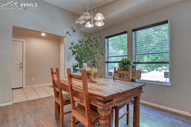 Dining room featuring a chandelier and light wood-type flooring