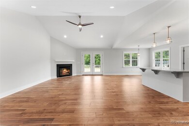 Unfurnished living room with vaulted ceiling, ligh