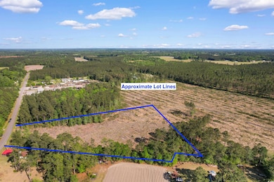 Birds eye view of property with a wooded view