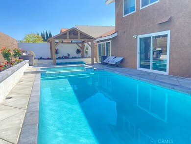 Entertaining backyard with sliding glass doors from downstairs master bedroom