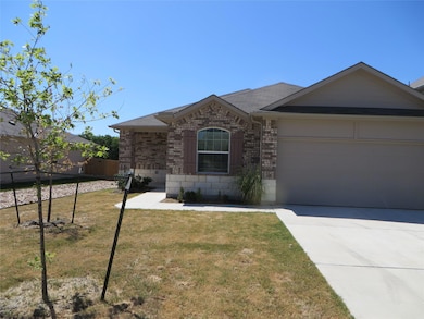 Ranch-style house with brick siding, a front yard
