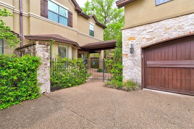 Entrance to property with stone siding, a garage,
