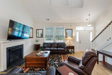 Living room with light hardwood / wood-style floor