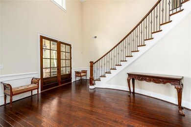Grand 2-Story Foyer  with Elegant Spiral Staircase with hardwood stair treads.