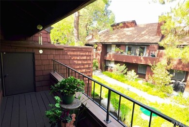 Balcony off of the living room facing mature trees