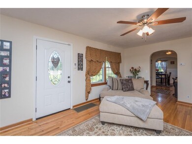 Large living room with hardwood floors, ceiling fa