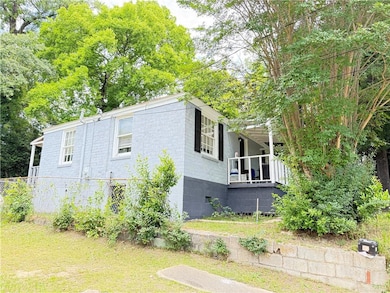 View of property exterior featuring concrete block siding and a lawn
