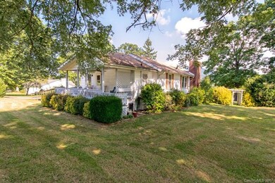 Covered porch and mature landscaping.