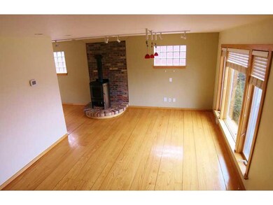 Living Room. Plenty of natural light and a wood bu