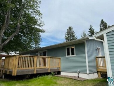 Back of property with a wooden deck