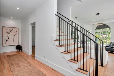 Features include high ceilings, wood floors and recessed lighting